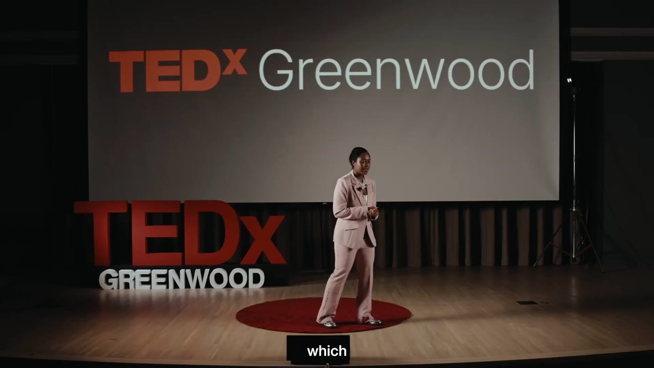 Jeneba Wint speaking on the TEDxGreenwood stage